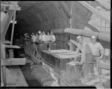Big Creek tour group riding rail cars through the Big Creek Powerhouse #4 power tunnel