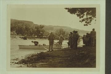 Preparing to leave town of Gateway, Colorado, during traverse of Dolores River. Pres Walker is in the punt and Marston holds it from the shore