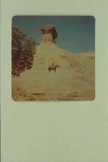 Tom Daly on the slick rock at foot of hammer heads. Side canyon of Little Finger Canyon, Navajo Canyon