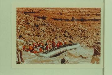 Georgie White's tribe on her boloneys plopping through Soap Creek Rapid. Ballard Atherton photographs the act from the left
