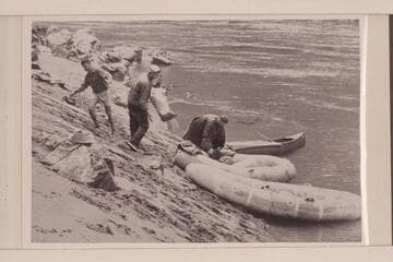 Rogue River party of UC students; six in the party. Traverse of Rogue River with life rafts and a canoe. Loading at Whisky Creek