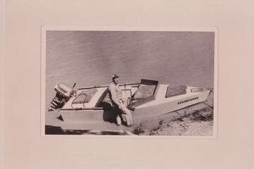 Al Morton's boat "Adventurer." His son-in-law stands beside it. The craft copies the sadiron lines with little acceptance of the usual design for power use