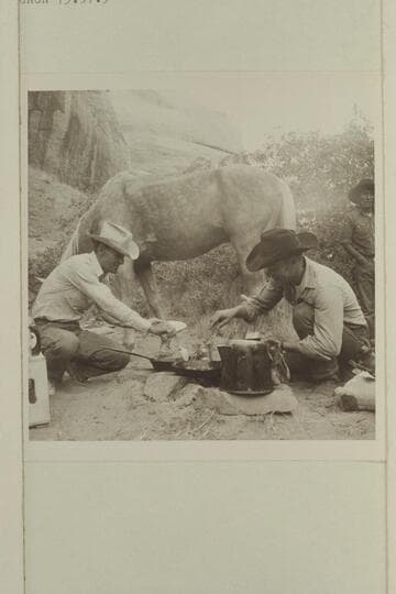 Tom Daly and Buster Ordiway create pancakes in camp of middle fork. Tobe Owl at right