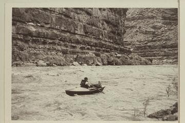 Jack near the bottom of Slickhorn Rapid. Jack Wimpress in the "Black Submarine" or "Ugh Ptui."