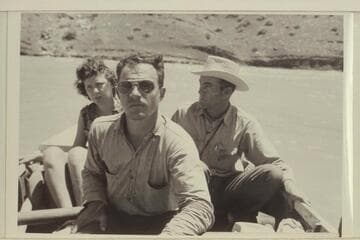 Skipper Frost at the oars in the Piute Farms section of the San Juan. Mrs. Paul B. Meadows and Phillip T. Hayes