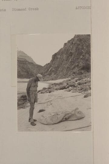 John Doerr examines the life raft lost by the Scout Troop in Glen Canyon and found by the Nevills party at Mile 219 in Grand Canyon. Diamond Creek