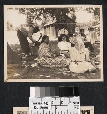 William Benson with phonograph, at left.  Mary Knight Benson seated with fan, and Grace Nicholson facing camera, center