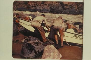 Portage of "Mexican Hat II." John Harper at the bow; Duane Bishop and Willard Wright on far side. Frank Wright and Bill Thompson on near side. Georgie White ran her party through the rapid the same day